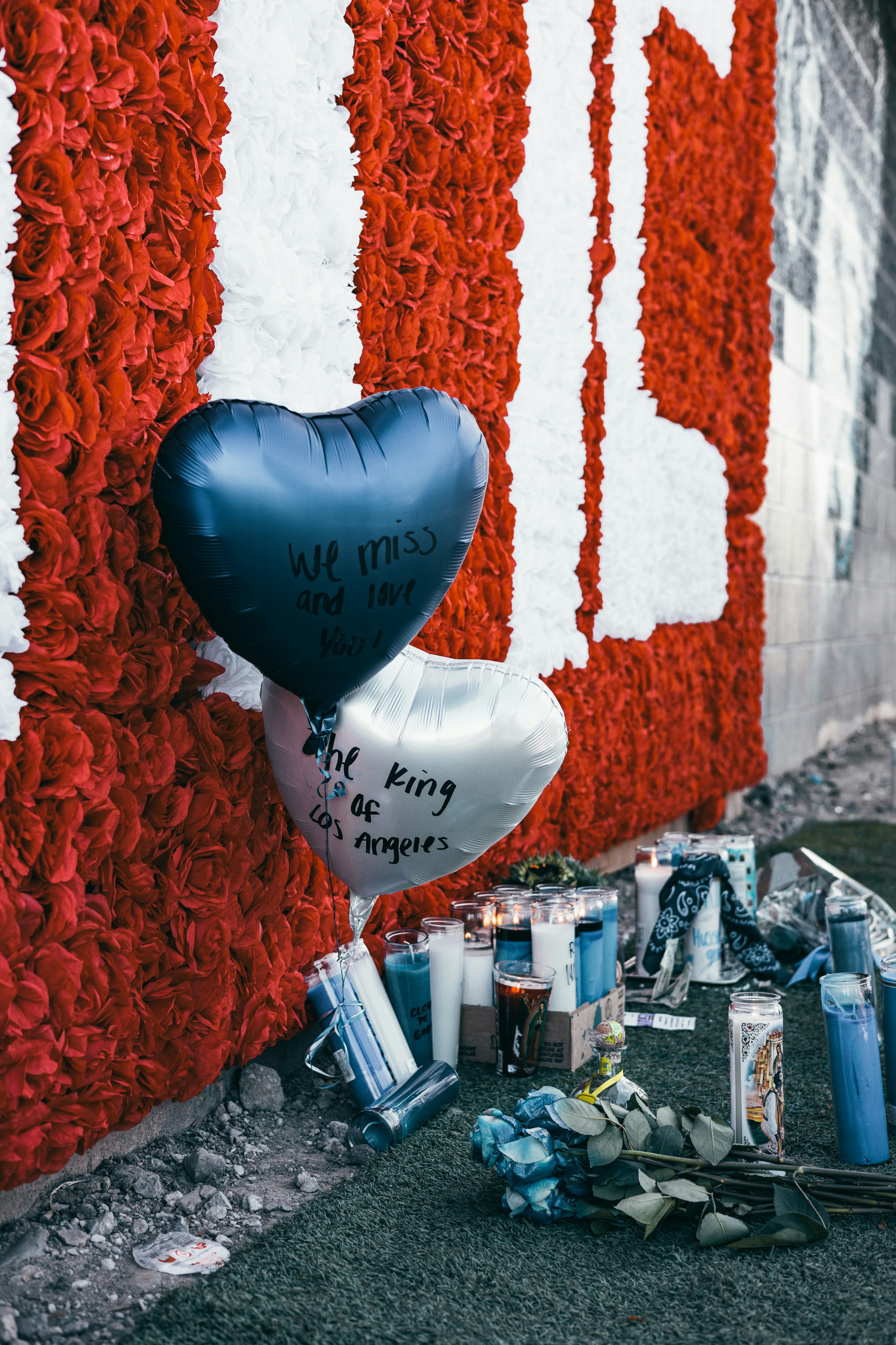 blue balloon near white and red plastic bottles